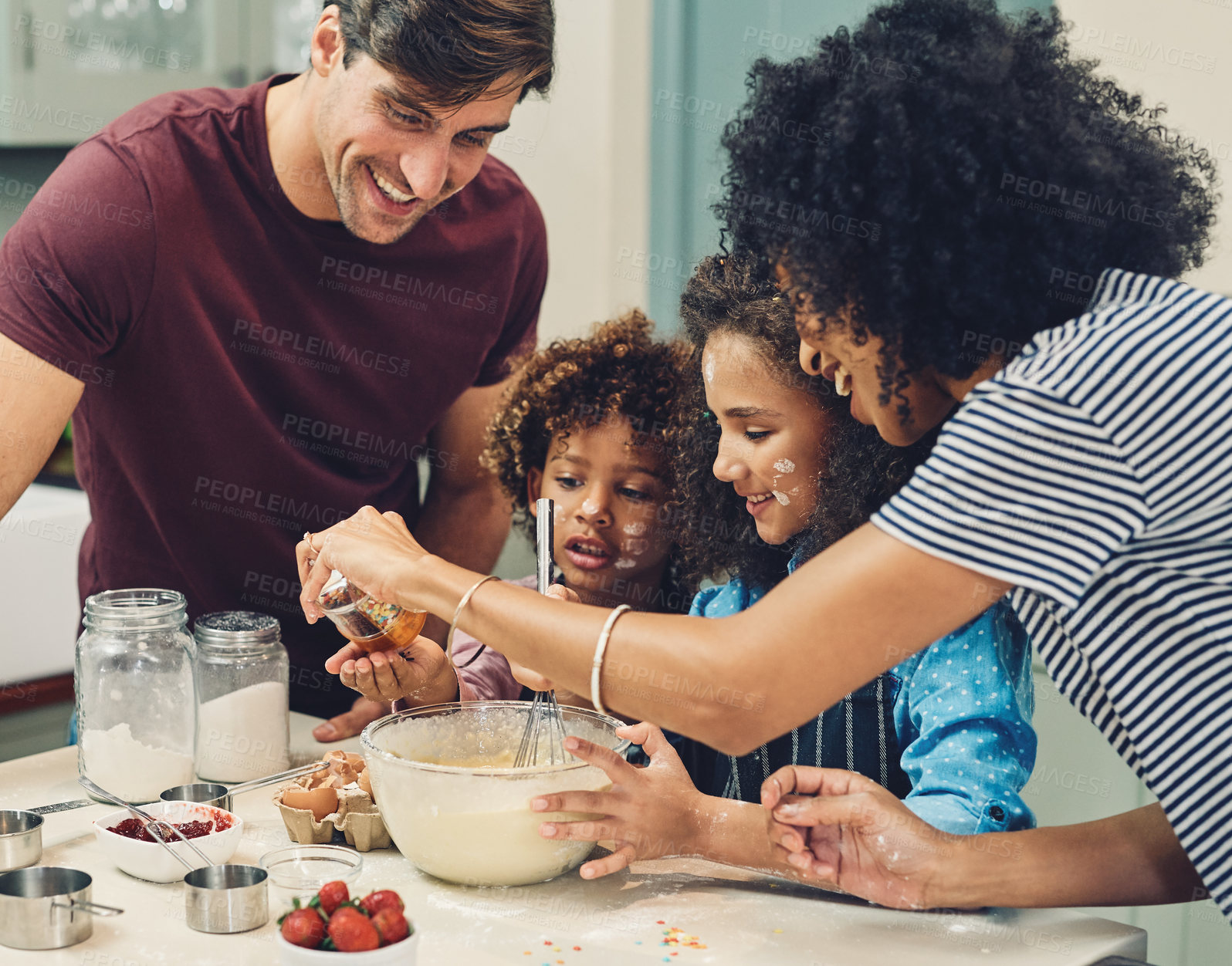 Buy stock photo Cropped shot of a young couple baking at home with their two children