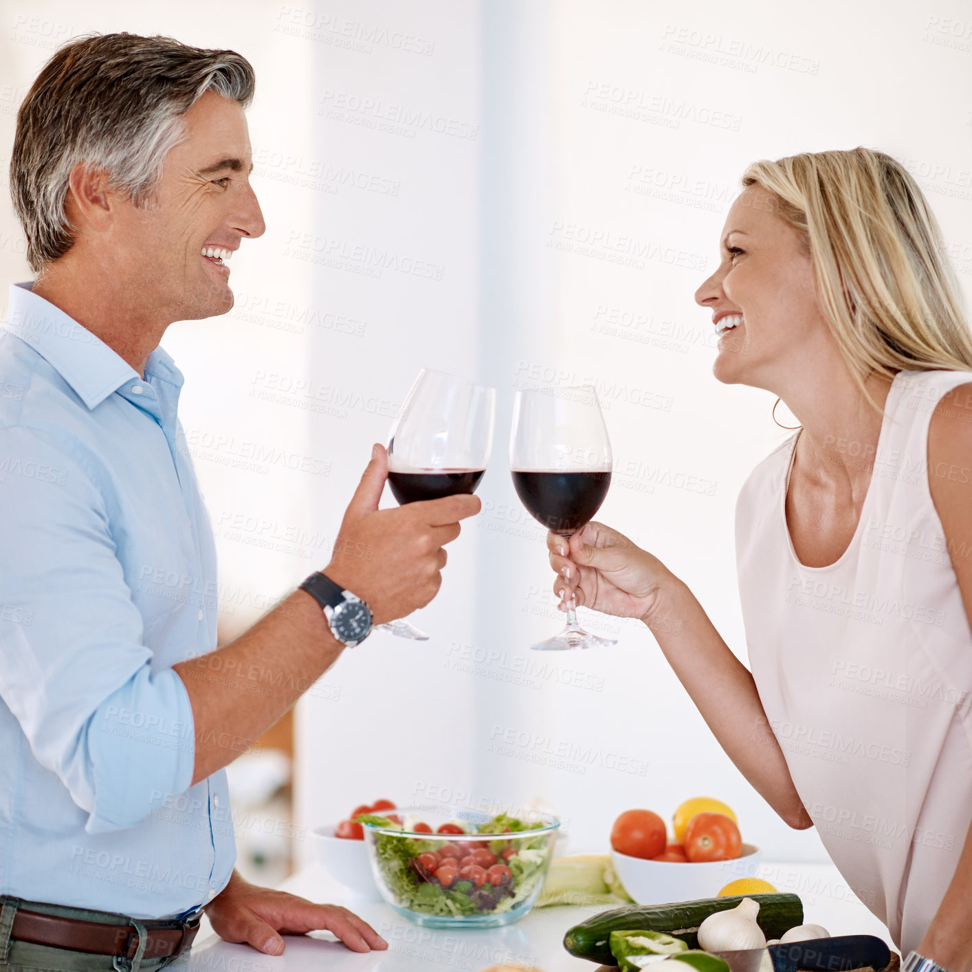 Buy stock photo Mature man, happy woman and wine toast with love, laugh and together for bonding in kitchen. Married couple, anniversary and cheers with alcohol for healthy meal, nutrition or romantic dinner in home