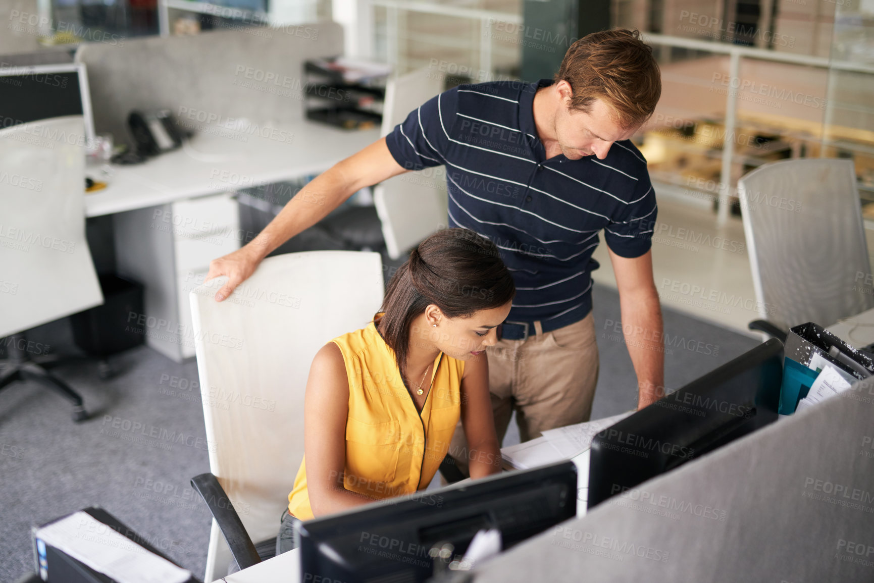 Buy stock photo Cropped shot of two business colleagues working together in their office