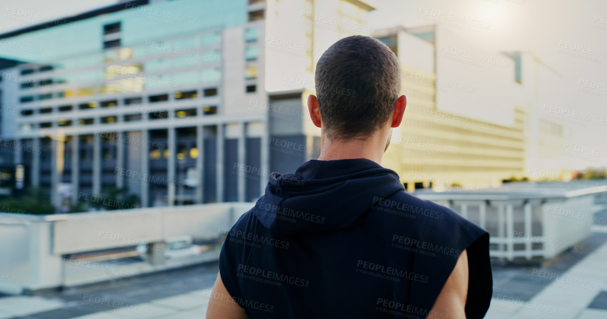 Buy stock photo Rearview shot of a young man going for a workout in the city
