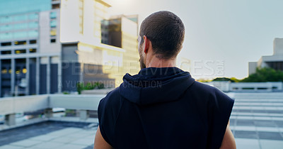 Buy stock photo Back, training and man thinking in city for running, cardio workout or endurance exercise. Lens flare, sports and athlete for parkour preparation, fitness or thoughtful on rooftop in urban town