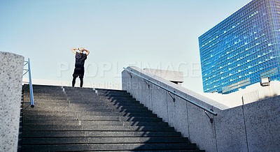 Buy stock photo Rearview shot of a young man running up stairs in the city