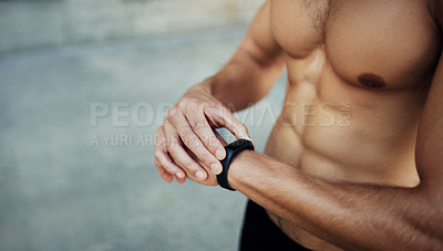 Buy stock photo Cropped shot of an unrecognizable shirtless man looking at his watch while exercising in the city