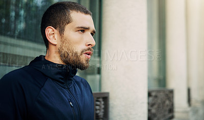 Buy stock photo Shot of a young man going for a workout in the city