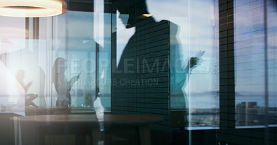 Buy stock photo Silhouette shot of businesspeople in an office building