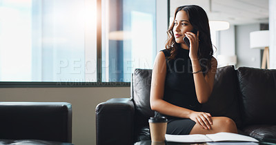 Buy stock photo Shot of a businesswoman talking on her cellphone while sitting in a modern office