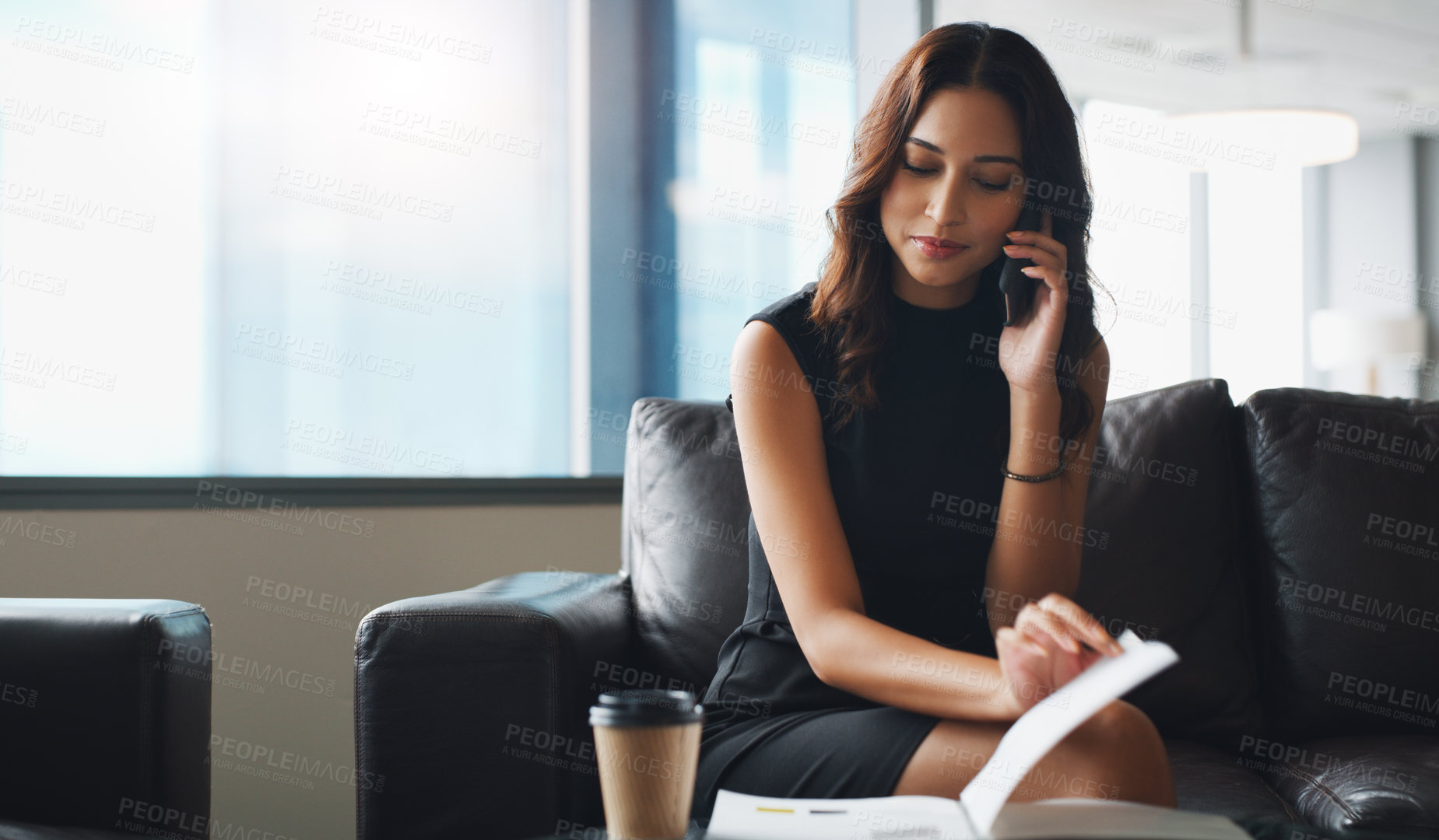 Buy stock photo Shot of a businesswoman talking on her cellphone while sitting in a modern office