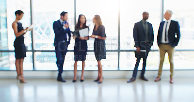 Buy stock photo Shot of a group of businesspeople standing in a modern office