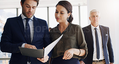 Buy stock photo Shot of two businesspeople discussing something while walking together