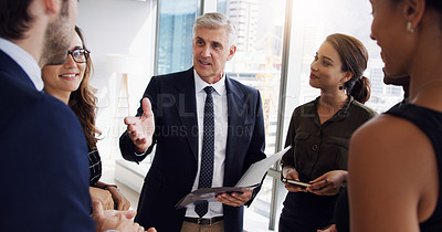 Buy stock photo Shot of a businessman having a meeting with his coworkers