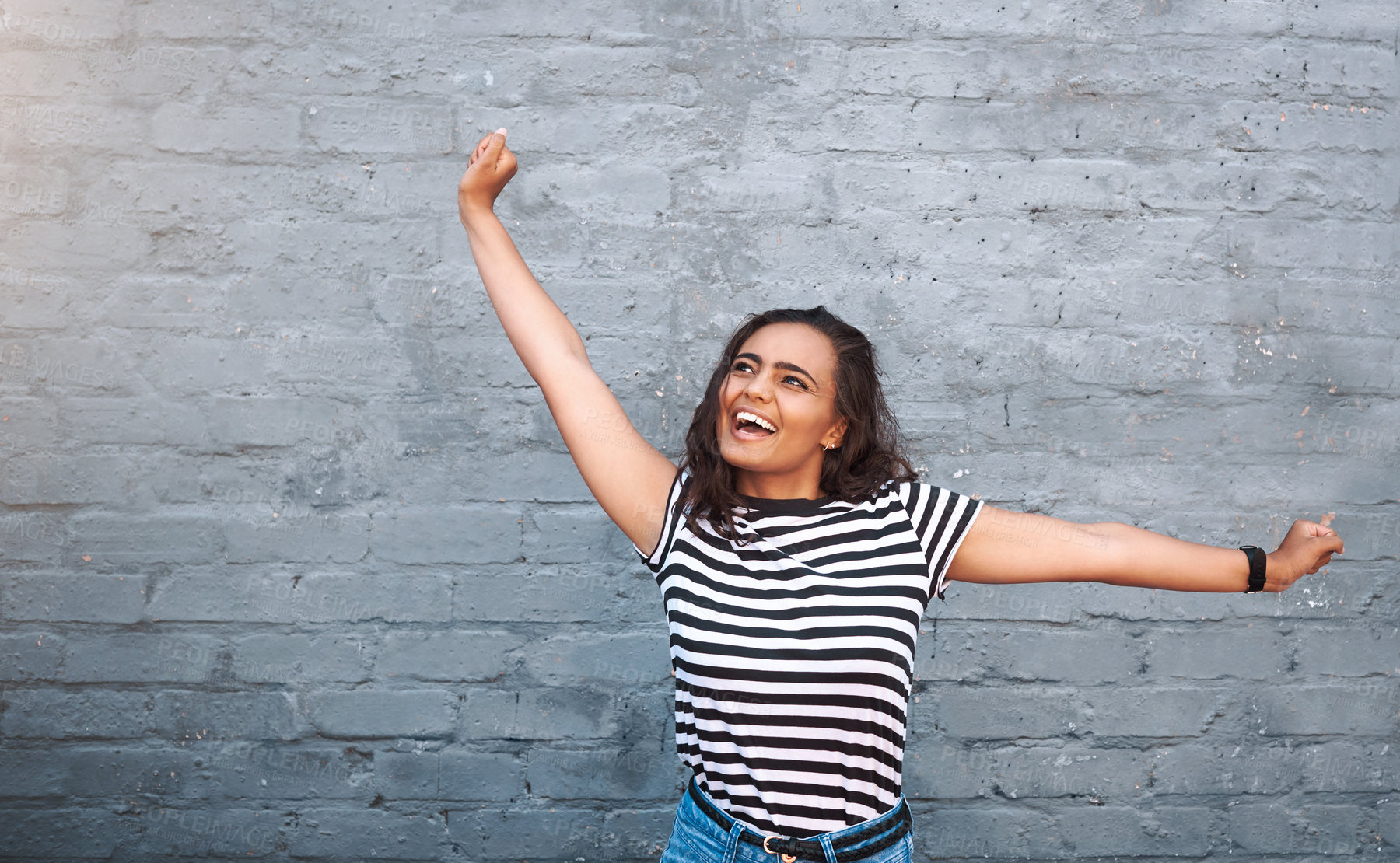 Buy stock photo Brick, wall and dance of girl, excited and outdoor for freedom, smile and break in weekend for fun. Dancer, person and happiness for holiday, summer and goofy in streetwear, tshirt and clothes