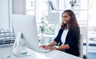 Buy stock photo Shot of a young call centre agent working in an office