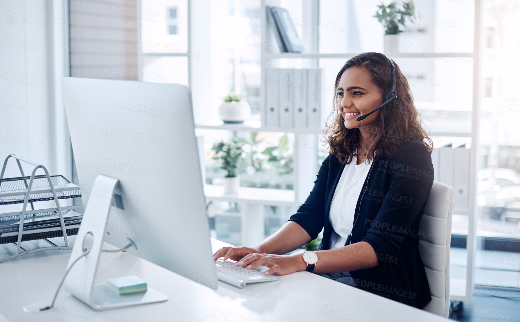 Buy stock photo Shot of a young call centre agent working in an office