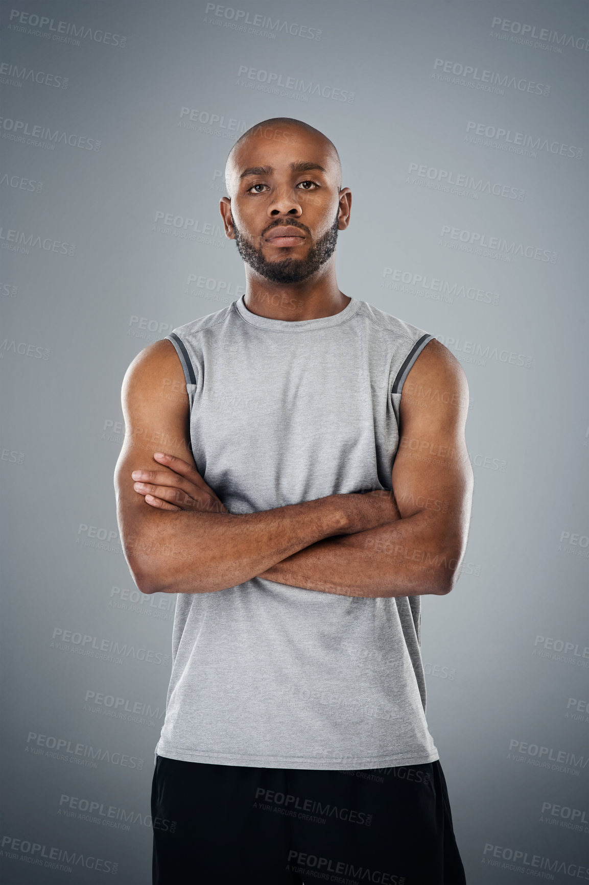 Buy stock photo Shot of a sporty young man posing against a grey background