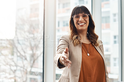 Buy stock photo Portrait of a cheerful young businesswoman reaching out for a handshake in her office