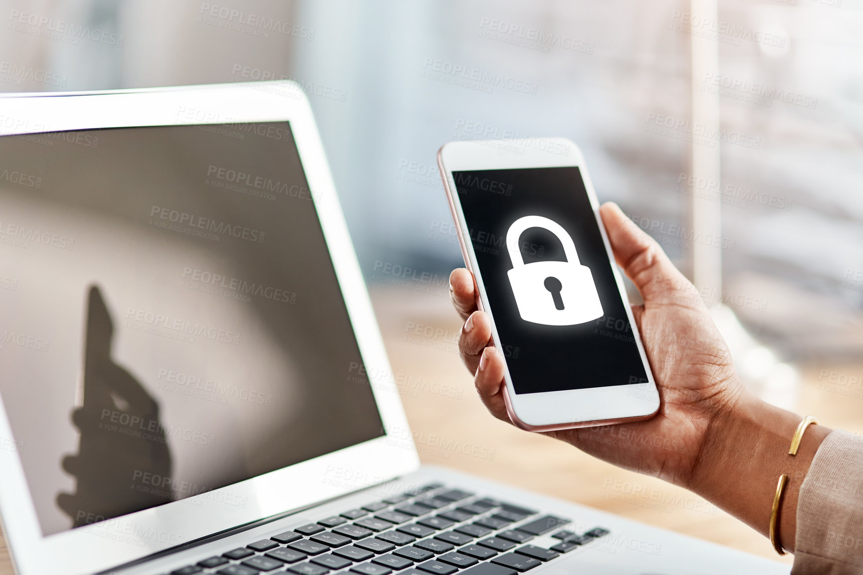 Buy stock photo Shot of an unrecognizable businesswoman using a cellphone and laptop in her office