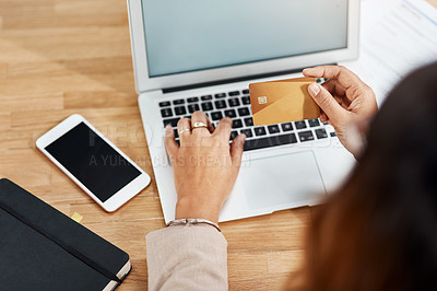 Buy stock photo Shot of an unrecognizable businesswoman using a credit card and laptop to shop online in her office