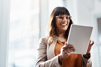 Buy stock photo Shot of an attractive young businesswoman using a digital tablet in her office