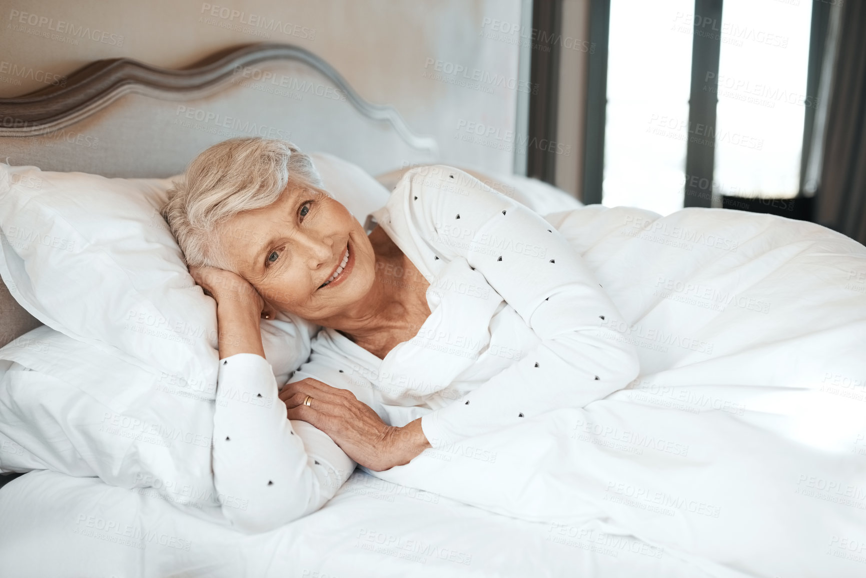 Buy stock photo Shot of a senior woman relaxing in bed in a nursing home