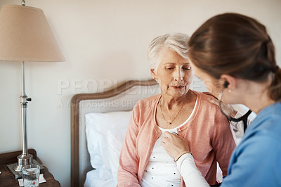 Buy stock photo Shot of a senior woman getting a checkup from a young nurse in a retirement home