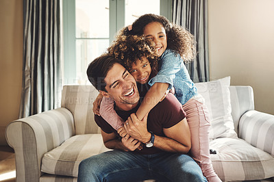 Buy stock photo Shot of a happy young father playing with his two children at home