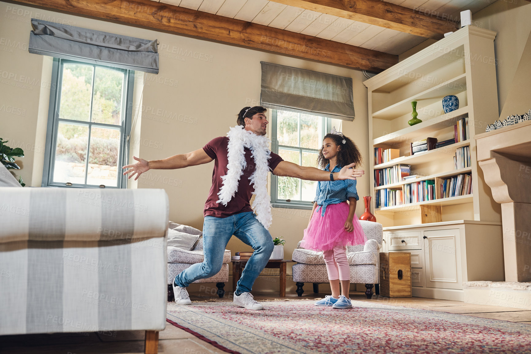 Buy stock photo Full length shot of a happy young father playing dress up with his daughter at home