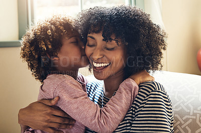 Buy stock photo Shot of an adorable little boy kissing his mother on the cheek while bonding together at home