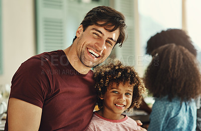 Buy stock photo Portrait of a cheerful father and son bonding during a family gathering at home