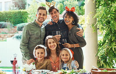 Buy stock photo Portrait of a beautiful young family posing together while celebrating at Christmas lunch party