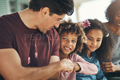 Buy stock photo Shot of a beautiful young family bonding and spending time together at home
