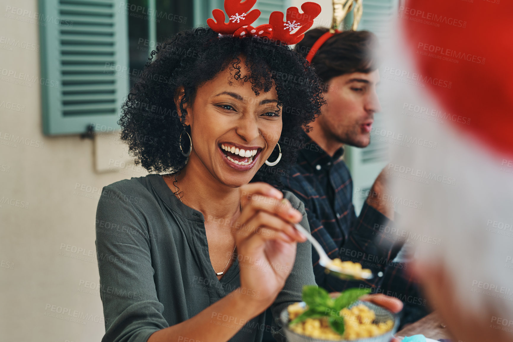 Buy stock photo Shot of beautiful young woman enjoying herself at Christmas lunch party with friends and family