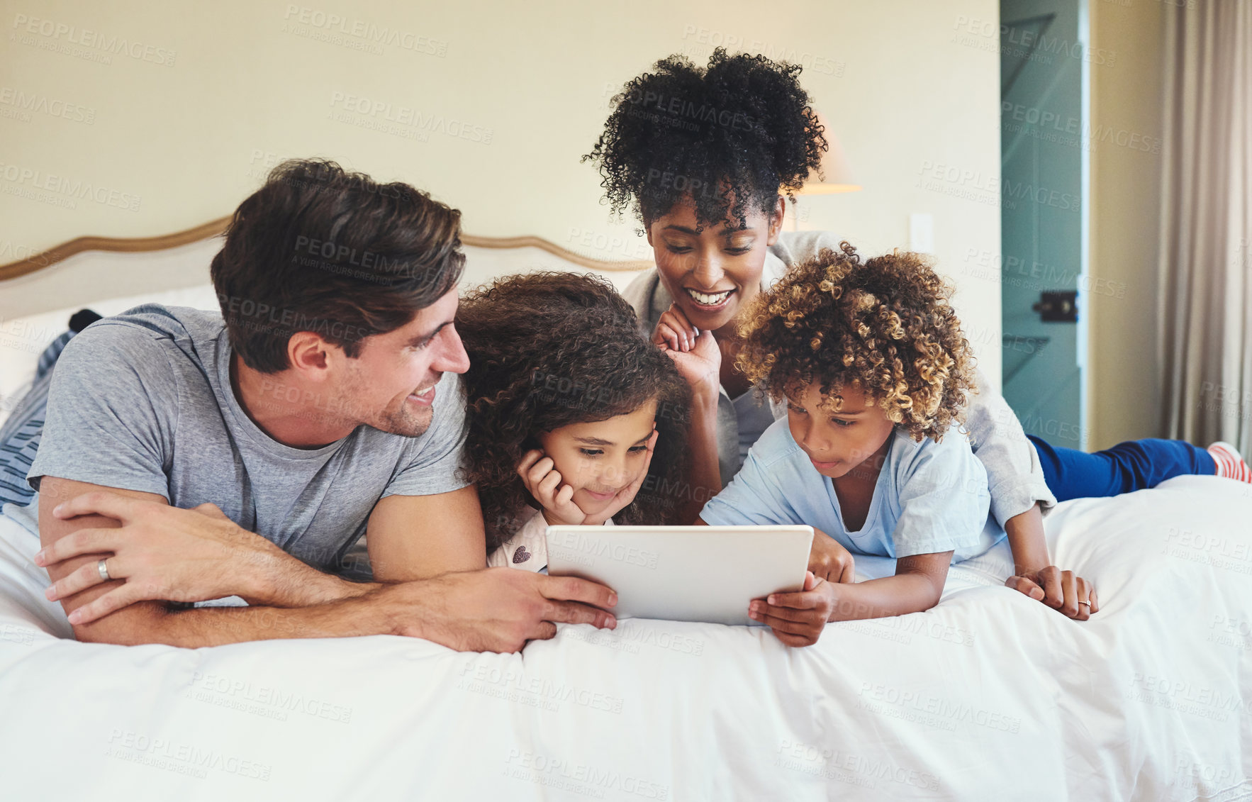 Buy stock photo Shot of a family using a digital tablet together at home