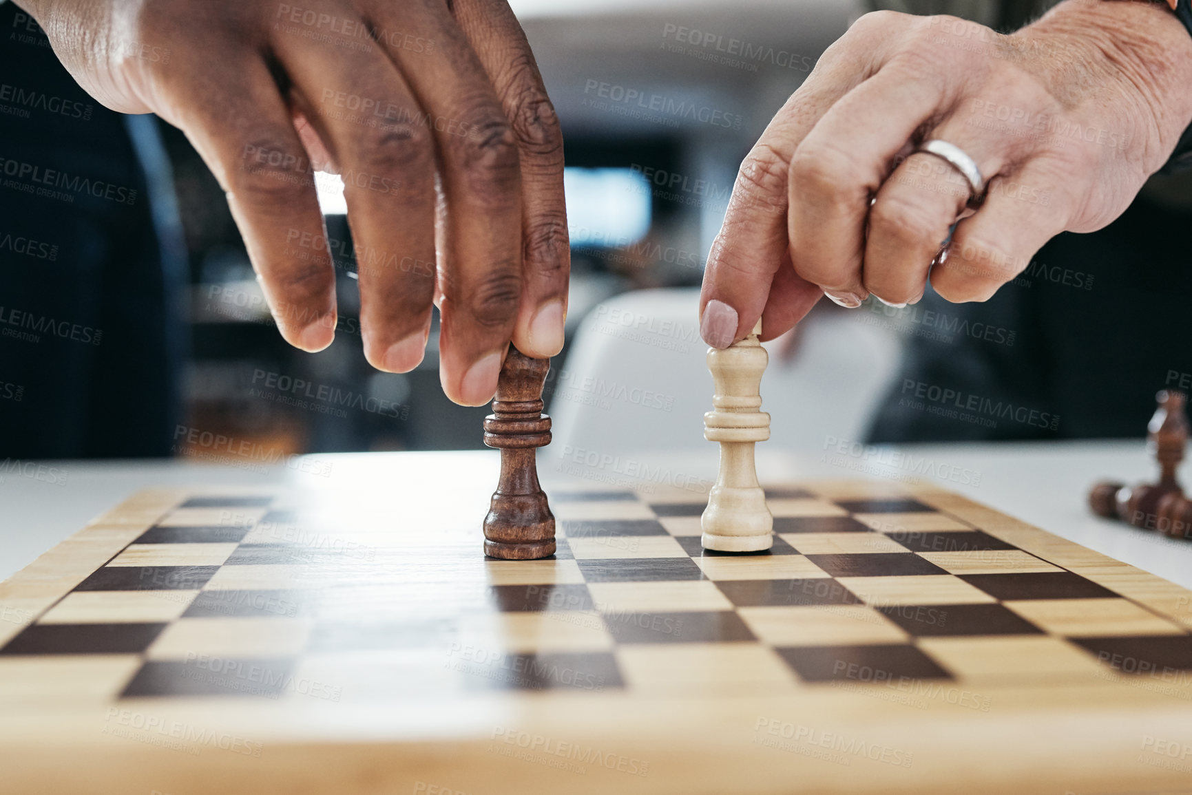 Buy stock photo Shot of two unrecognizable businesspeople playing a game of chess together inside their office at work