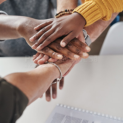 Buy stock photo Shot of a group of unrecognizable businesspeople joining hands together in solidarity inside their office at work