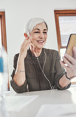 Buy stock photo Business, earphones and mature woman with mobile at desk for listening to music, streaming podcast or radio in office. Online, smile and employee with smartphone for happiness, audio or playlist