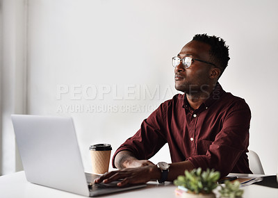 Buy stock photo Cropped shot of a handsome young businessman looking contemplative while sitting alone at his desk in the office
