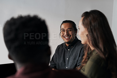 Buy stock photo Cropped shot of a group of young businesspeople sitting and having a meeting in the offic