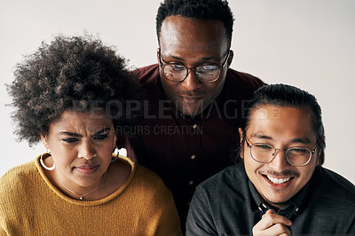 Buy stock photo Cropped shot of a group of young businesspeople sitting and working together in the office during the day