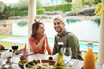 Buy stock photo Cropped shot of a couple sitting down for a meal on Christmas day