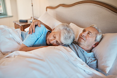 Buy stock photo Cropped shot of an affectionate senior couple cuddling each other while asleep in bed at a nursing home