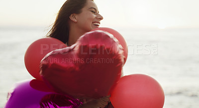 Buy stock photo Cropped shot of a beautiful young woman holding heart-shaped balloons
