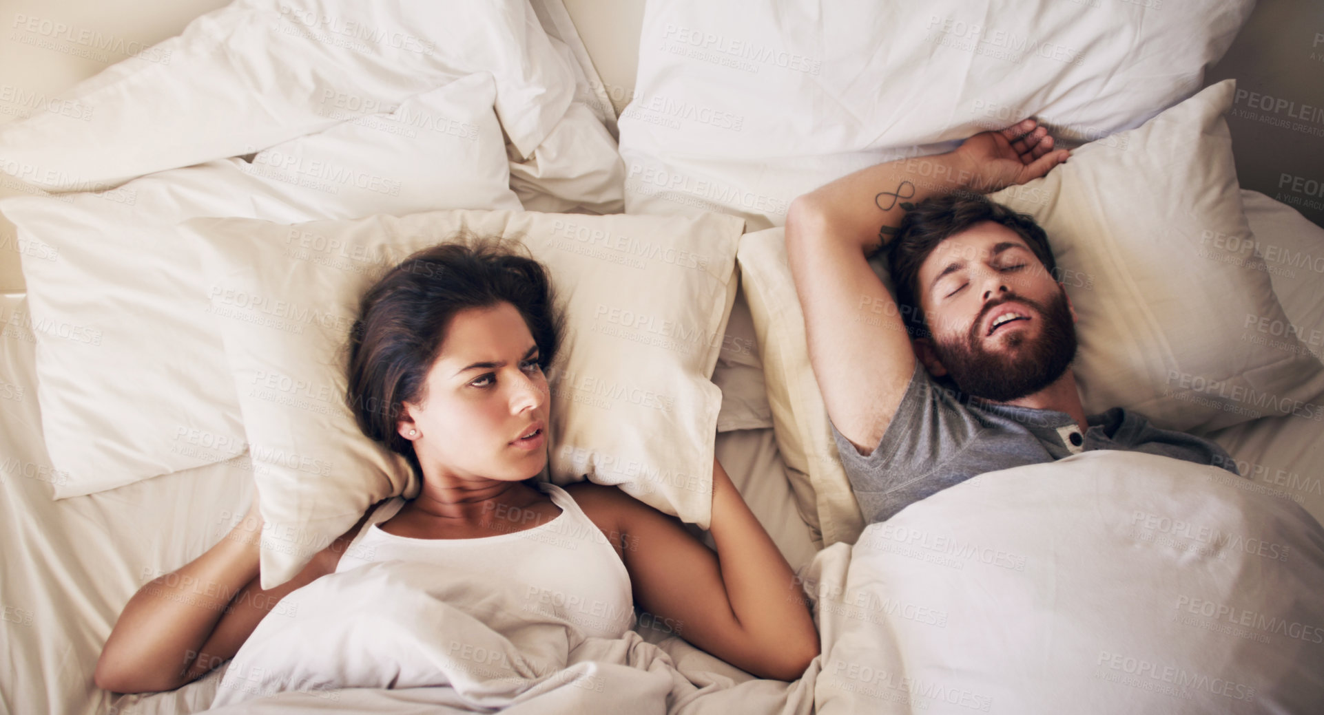 Buy stock photo Frustrated woman, snoring man and bed in a home with angry female person from noise. Tired, sleeping and morning with young people in a bedroom in a house together with a fight, anger and fatigue