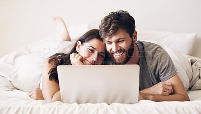 Buy stock photo Embrace, couple and relaxing with laptop on bed for bonding by watching movie, film and comedy together at house. Man, woman and care with smile in bedroom for streaming funny show as entertainment