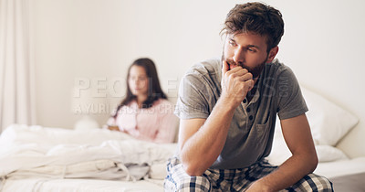 Buy stock photo Shot of a young couple having an argument in the bedroom at home