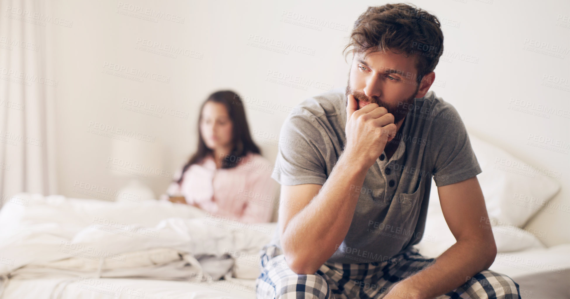 Buy stock photo Shot of a young couple having an argument in the bedroom at home