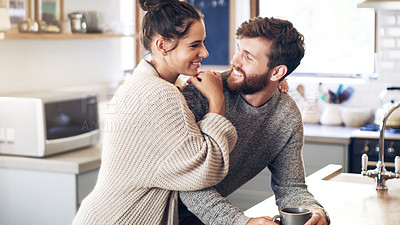 Buy stock photo Shot of a happy young couple having coffee together in the kitchen at home
