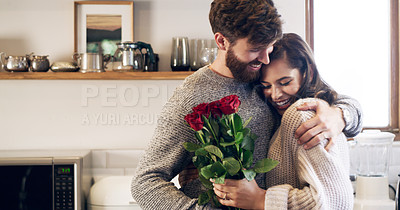 Buy stock photo Shot of a young man surprising his wife with a bunch of roses at home