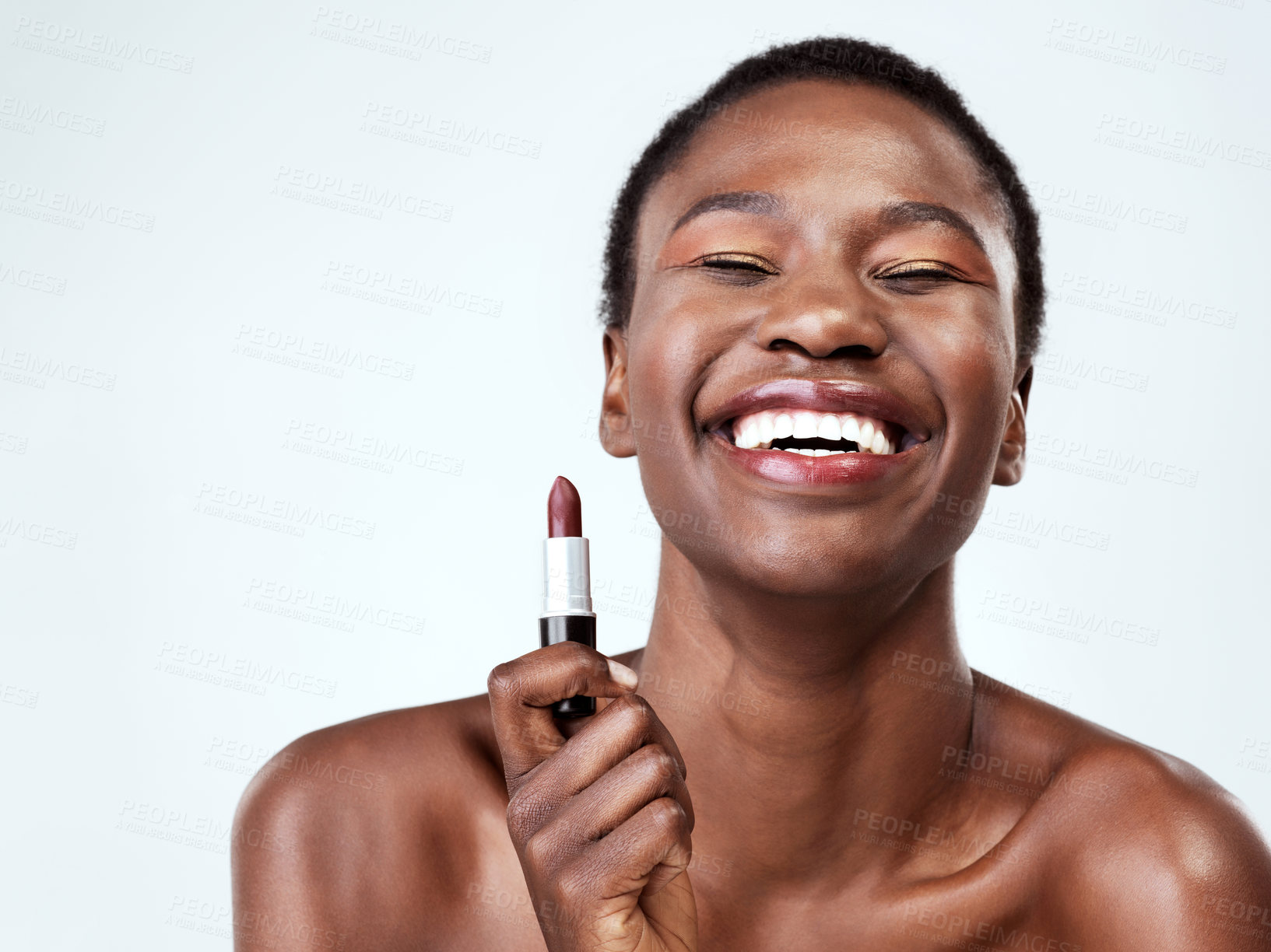 Buy stock photo Studio shot of a beautiful young woman applying red lipstick against a grey background