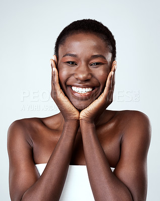 Buy stock photo Studio portrait of a beautiful young woman feeling her skin against a grey background