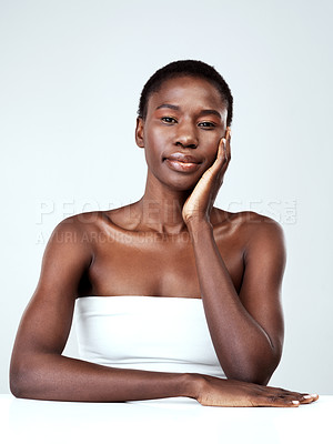 Buy stock photo Studio portrait of a beautiful young woman feeling her skin against a grey background